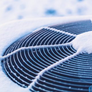 Air conditioning unit covered in snow