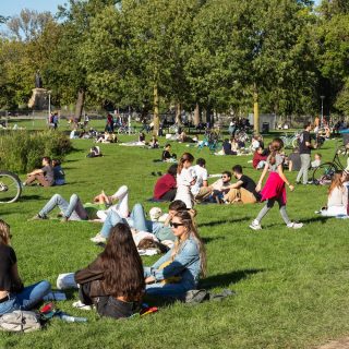 Amsterdam, Netherlands, September 24, 2023; People enjoy the beautiful weather on a lawn near the water in the Vondelpark.; Shutterstock ID 2401528215; purchase_order: TNO / ET; job: Energy.nl; client: